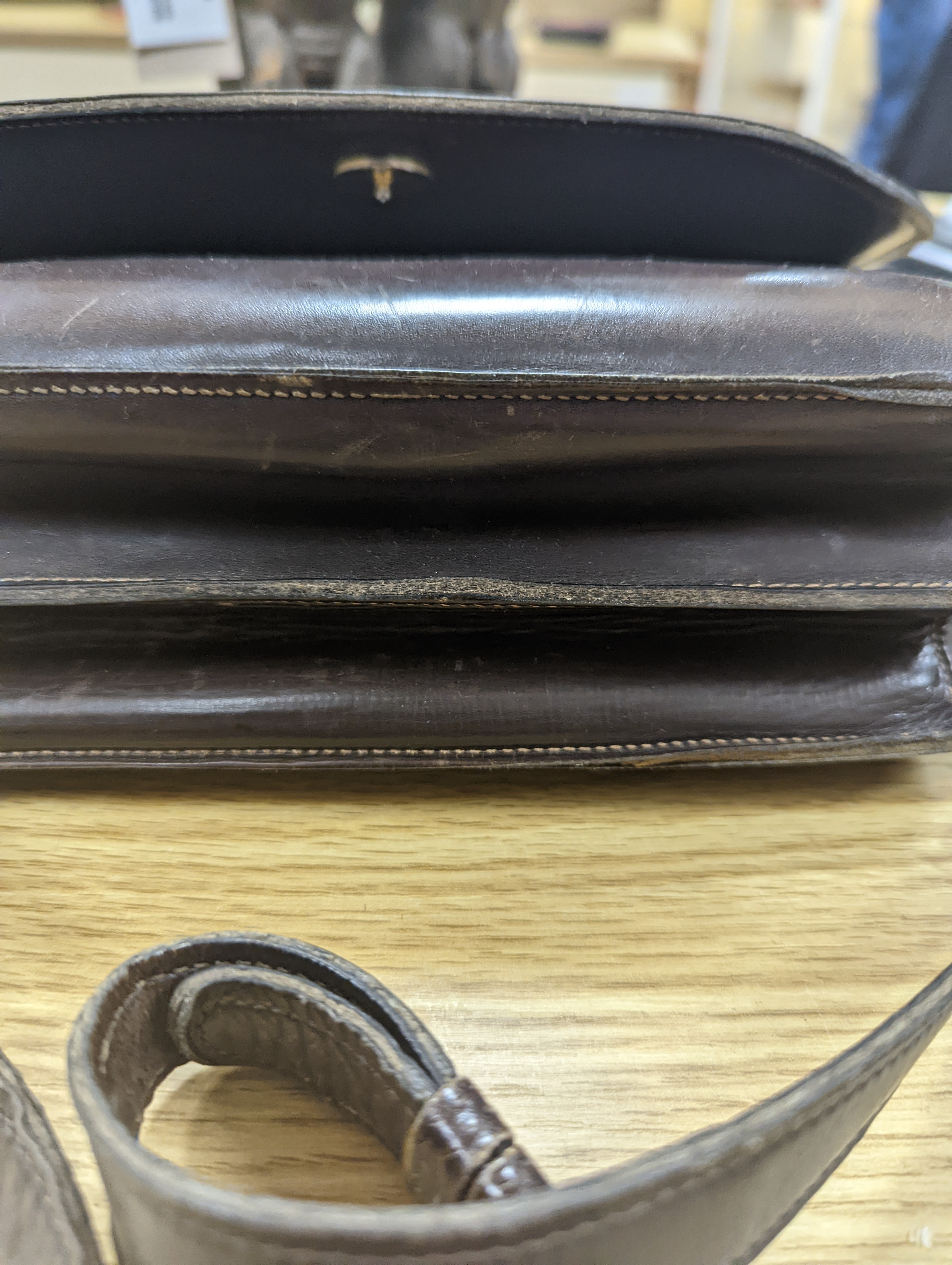 A vintage brown leather handbag stamped 